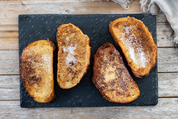 Traditional Spanish torrijas for Holy Week on wooden table. French Toast