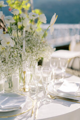 Served festive table with white bouquet of flowers