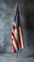 A classic American flag displayed proudly on a wooden stand against a white background