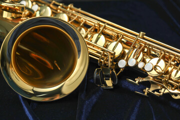 Fototapeta premium Jazz. One beautiful saxophone on black background, closeup