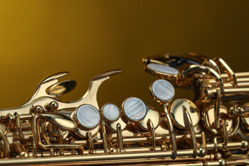 Jazz. One beautiful saxophone on color background, closeup
