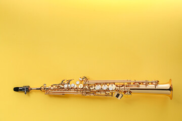 Jazz. One saxophone on yellow background, top view. Space for text