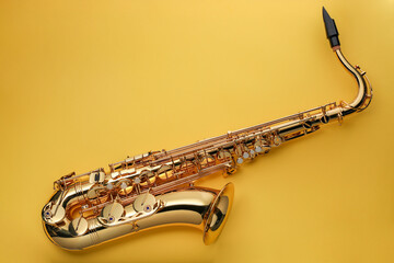 Jazz. One saxophone on yellow background, top view. Space for text