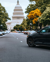 Black Car Stopped at a road with the United States Capitol Building in the Background