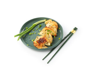 Tasty fried gyoza (dumplings), onion and chopsticks isolated on white