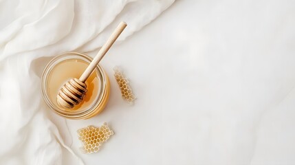 Fototapeta premium Honey Jar Wooden Dipper Honeycomb White Fabric Background
