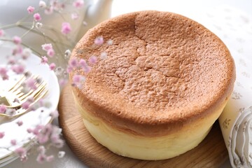 Tasty Japanese Castella sponge cake and gypsophila on table, closeup