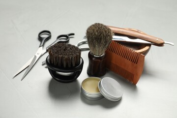 Many different barber's tools on light grey table, closeup