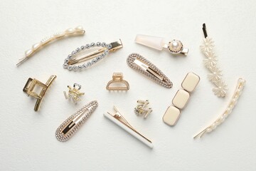 Different hair accessories on white table, flat lay