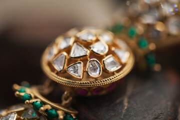Cose-up of a diamond bracelet with many stones and Gems on a black background.