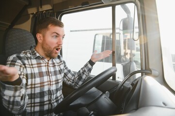 Shot of mad and nervous professional truck driver having arguing in traffic and yelling at someone....