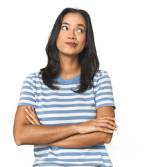 Young Latina posing in studio dreaming of achieving goals and purposes