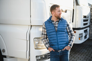 Confident male driver standing in front on his truck