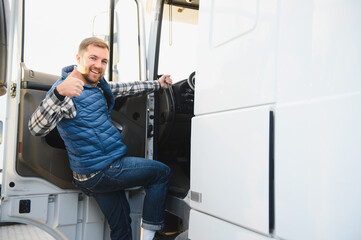 Truck driver climbing into cab of semi truck