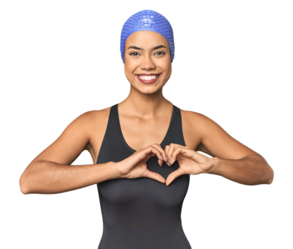 Pro Latina swimmer in studio gear smiling and showing a heart shape with hands.
