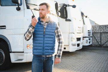 Truck driver talking on walkie-talkie