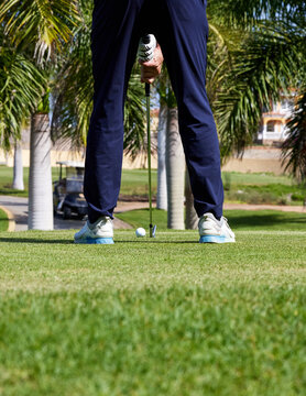 The golfer hits the golf ball with the Drive in his hand, on the tee.