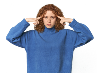 Young Caucasian redhead woman focused on a task, keeping forefingers pointing head.