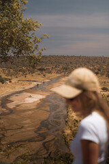 Tourist admiring tarangire river in tarangire national park during a safari trip in tanzania, africa