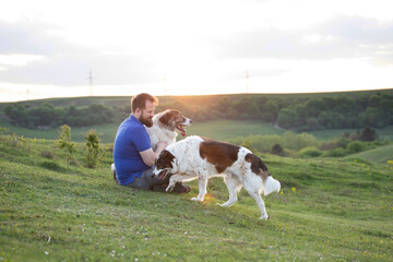 Happy dog and man playing outdoor