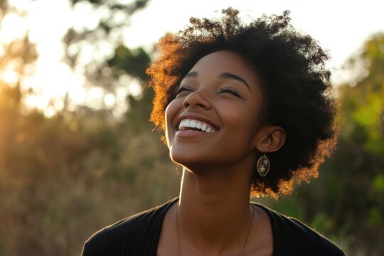 A woman smiles and looks up at the sky on a sunny day - Powered by Adobe