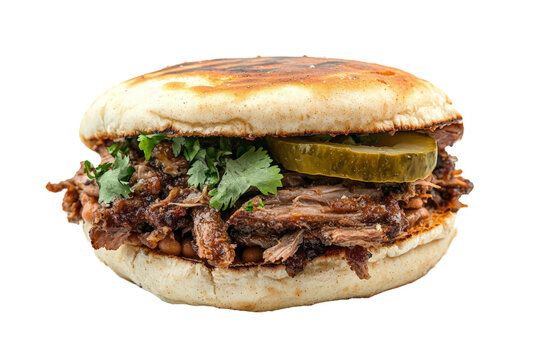 Mexican torta sandwich with carnitas, refried beans, and pickled jalape&ntilde;os, on a white background