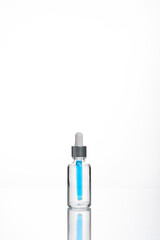 transparent dropper bottle with white bottom and colored dropper