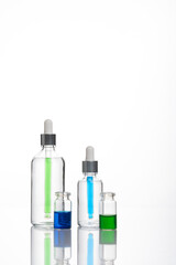 transparent dropper bottle with white bottom and colored dropper
