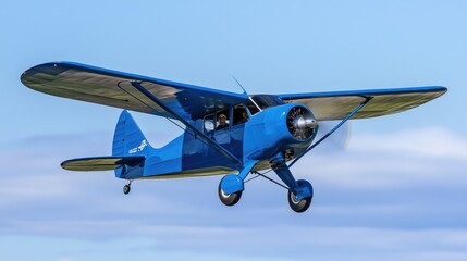 A small blue airplane soaring through a clear blue sky, ideal for travel or adventure themes