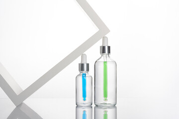 transparent dropper bottle with white bottom and colored dropper