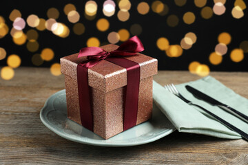 Beautiful table setting with romantic gift on wooden background, closeup