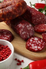 Different smoked sausages and spices on table, closeup