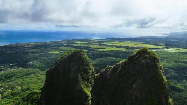 Drone flying near to the sunlit Kalalea King Kong mountain, in Kauai, Hawaii