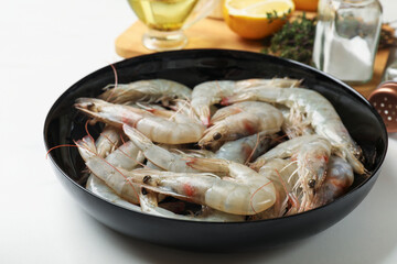 Fresh raw shrimps and spices on white table, closeup