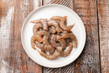 Fresh raw shrimps on wooden table, top view