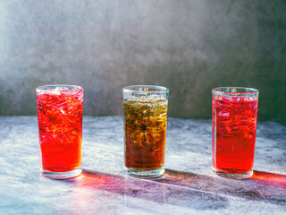 A lot of Soft drinks in colorful and flavorful glasses on the table,Glasses with sweet drinks with ice cubesv