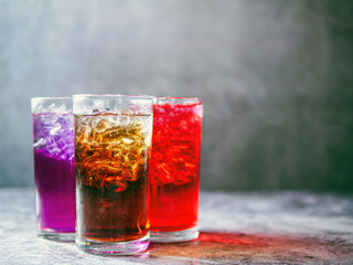A lot of Soft drinks in colorful and flavorful glasses on the table,Glasses with sweet drinks with ice cubesv