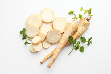 Parsley roots and leaves on white background, flat lay