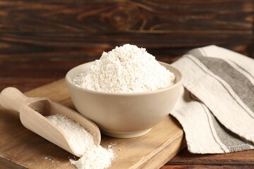 Brown rice flour on wooden table, closeup