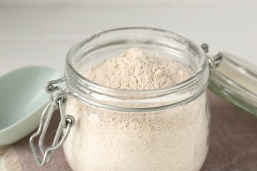 Brown rice flour on white table, closeup