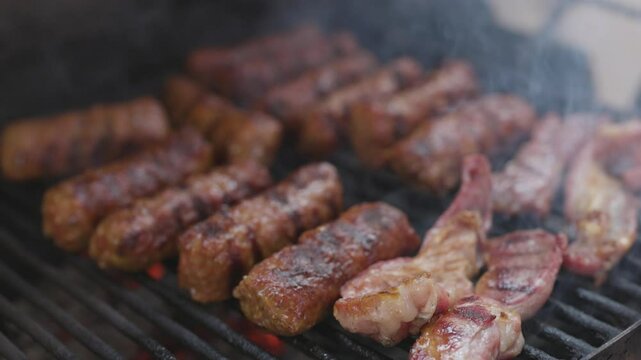 4k, with traditional Romanian product Mici on the grill during cooking.
