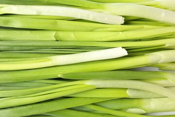 Fresh green onions as background, top view