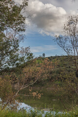 Beautiful lake landscape with trees and cloudy sky