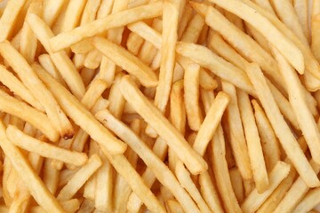 Pile of delicious French fries as background, top view
