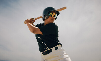 Confident baseball player prepared to swing as batter at home plate during daytime game