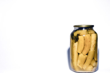 Canned pickles cucumber in glass jars. Pickle marinade cucumber in a jar. Jar with pickled gherkins on white background
