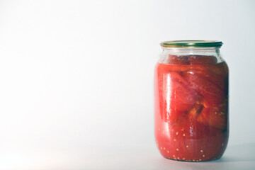 Canned sour tomatoes in glass jars. Pickled tomatoes in a jar.