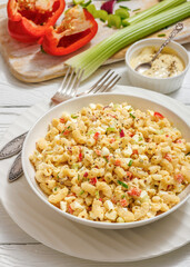 macaroni salad with celery, eggs, red bell pepper