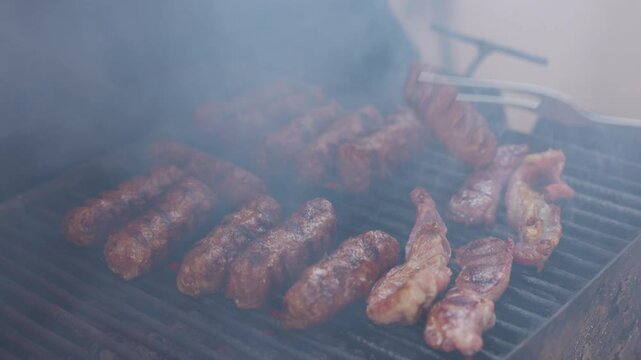 4k, with traditional Romanian product Mici on the grill during cooking.
