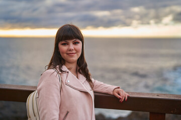 Stylish young woman posing by the ocean in Tenerife, Spain........